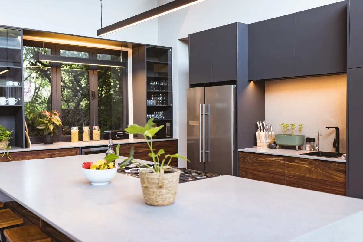 Modern bespoke kitchen installation with island unit and dark fitted cabinets