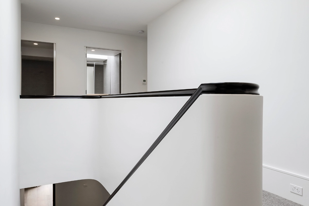 Modern staircase renovation with curved bannister and contemporary interior design