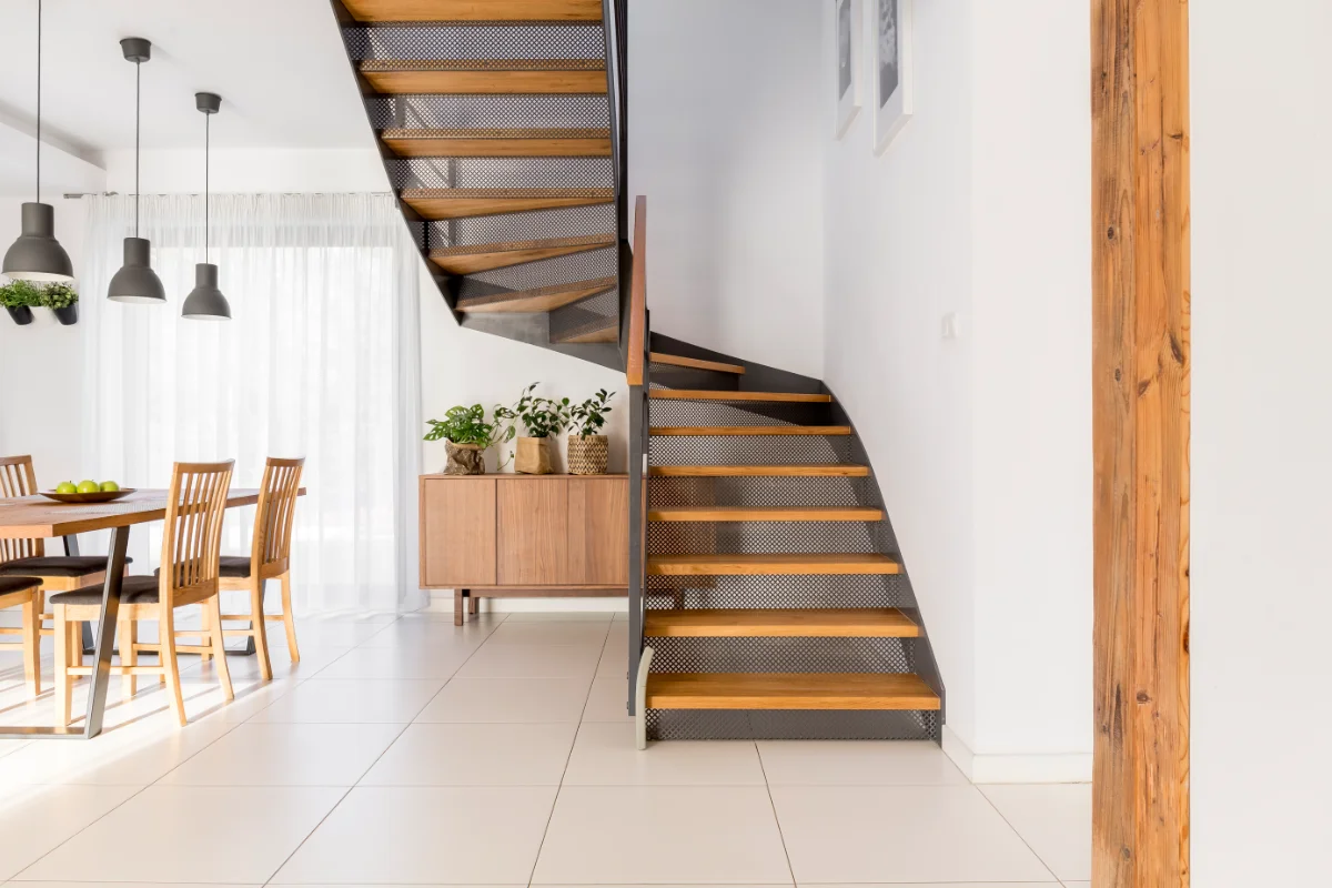 Modern staircase installation with wooden steps and contemporary interior design